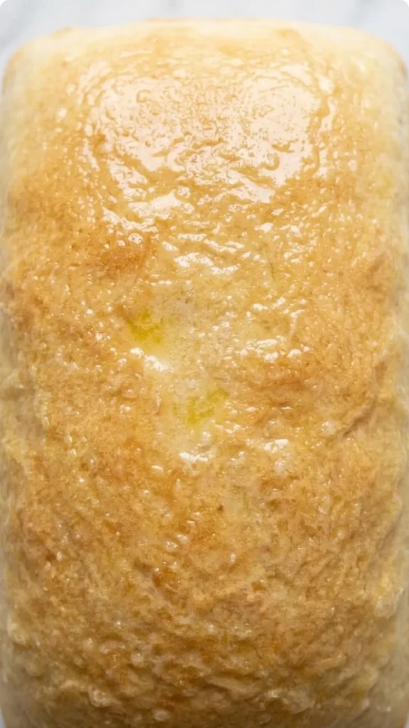 Nahaufnahme von Homemade Bread — Detailierte Ansicht der weichen, buttrig glänzenden Oberfläche des Kastenbrotes.