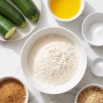 Zutaten für Zucchinikuchen mit altem Anstellgut: Mehl, Zucchini, Butter, brauner Zucker, Ei, Anstellgut und gemahlene Nüsse
